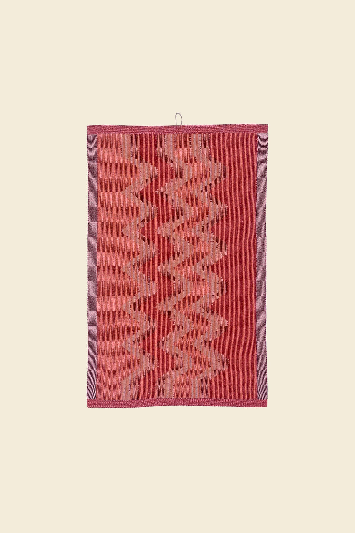 front view of red knit organic cotton kitchen towel with zig zag pattern