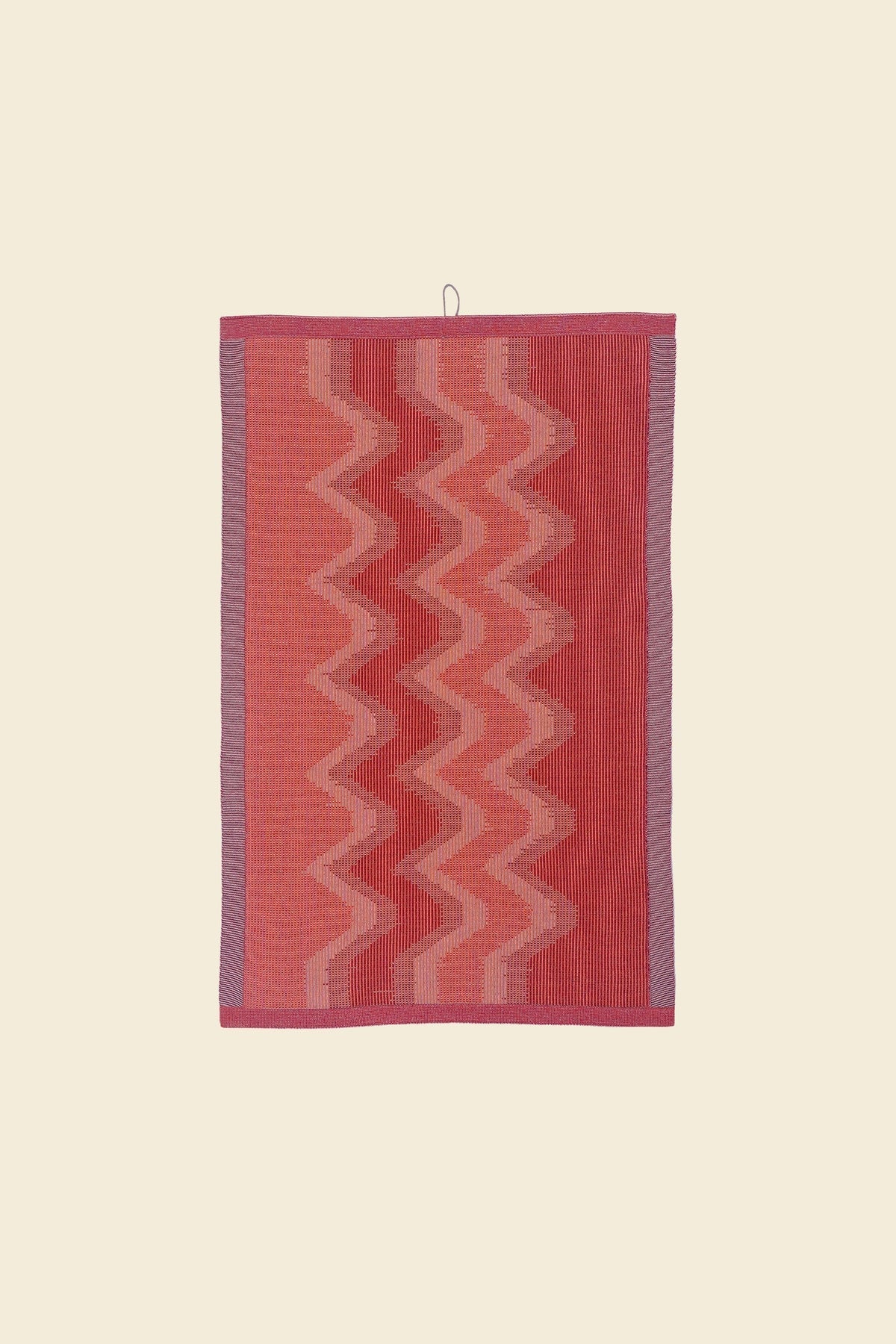 front view of red knit organic cotton kitchen towel with zig zag pattern
