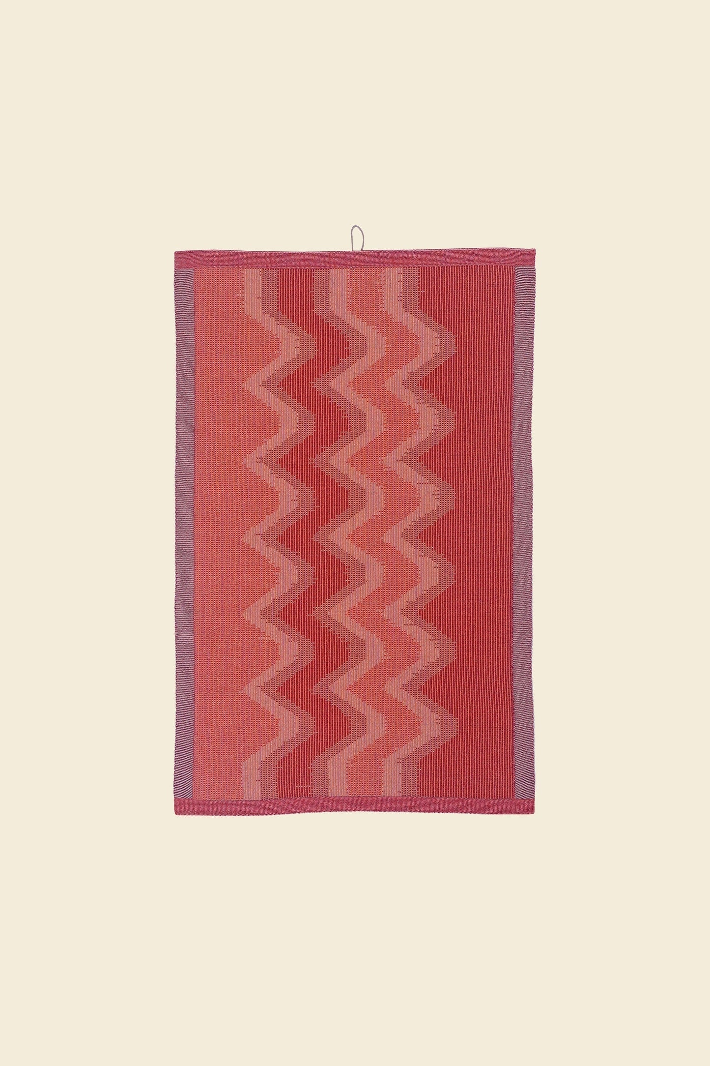 front view of red knit organic cotton kitchen towel with zig zag pattern
