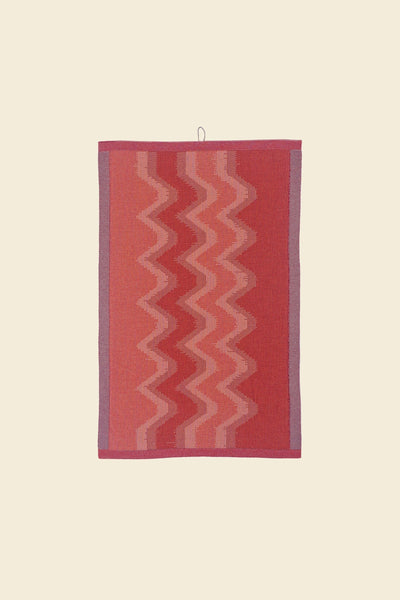 front view of red knit organic cotton kitchen towel with zig zag pattern