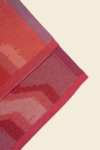 corner of red knit organic cotton kitchen towel set with zig zag pattern