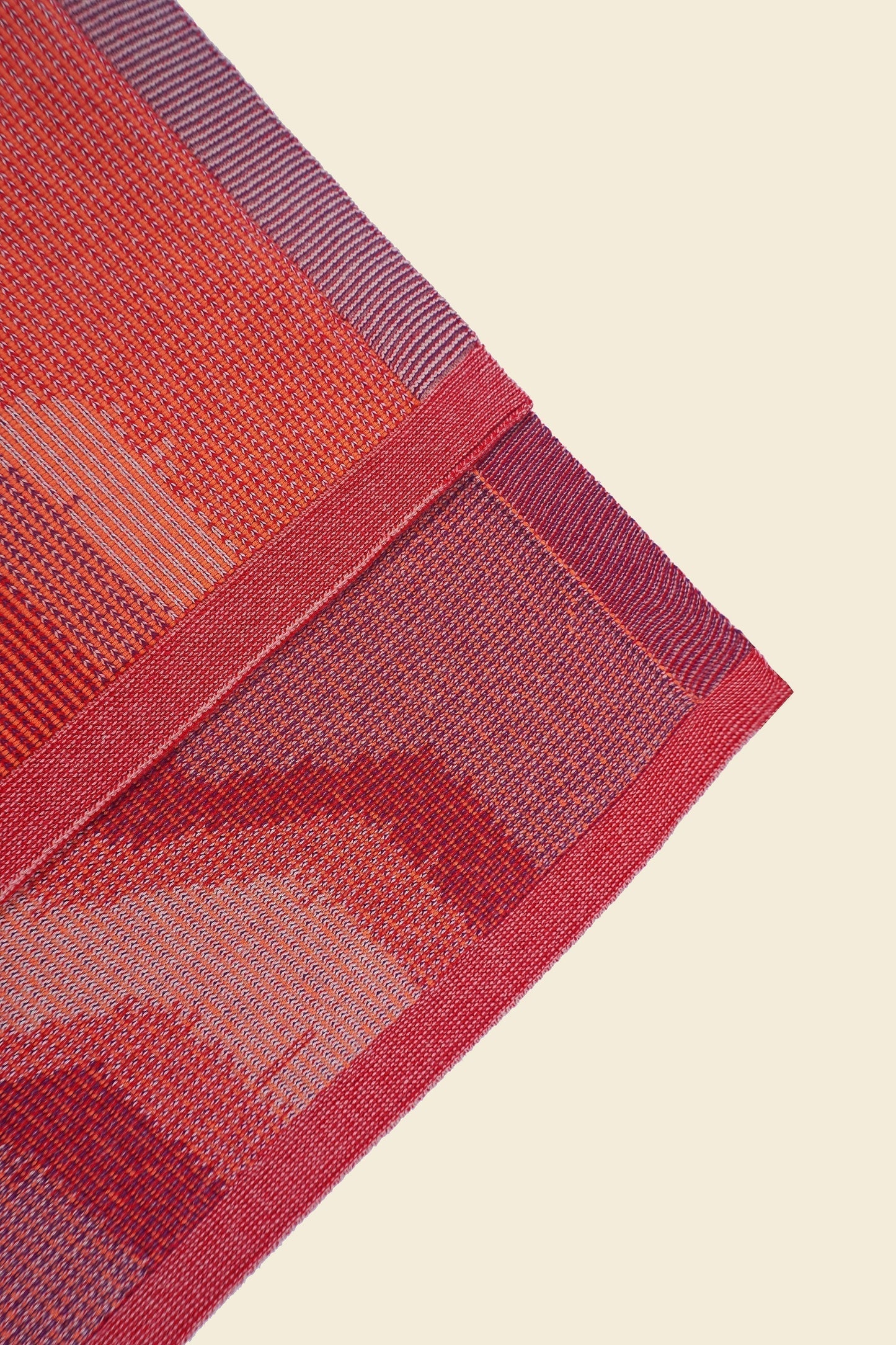 corner of red knit organic cotton kitchen towel set with zig zag pattern