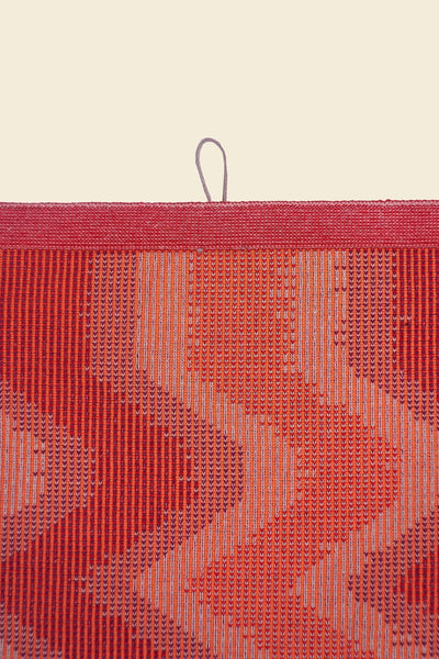 top detail of red knit organic cotton kitchen towel with zig zag pattern