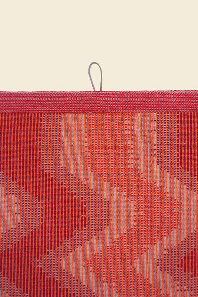 top detail of red knit organic cotton kitchen towel with zig zag pattern