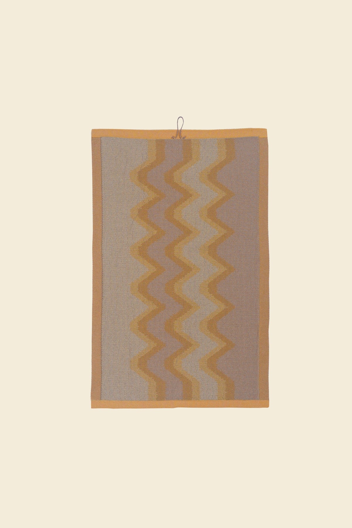 back side of yellow knit organic cotton kitchen towel with zig zag pattern