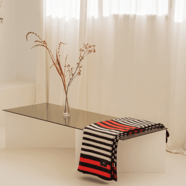 Load image into Gallery viewer, Viso Merino Blanket Black, White and Red Stripe table
