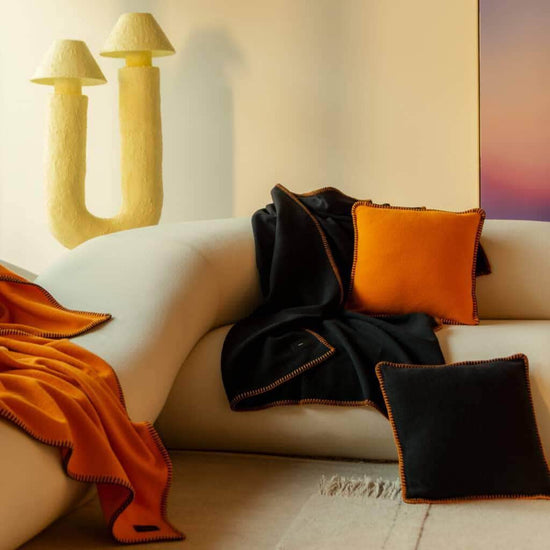 Load image into Gallery viewer, Viso Merino Blanket Black on sofa
