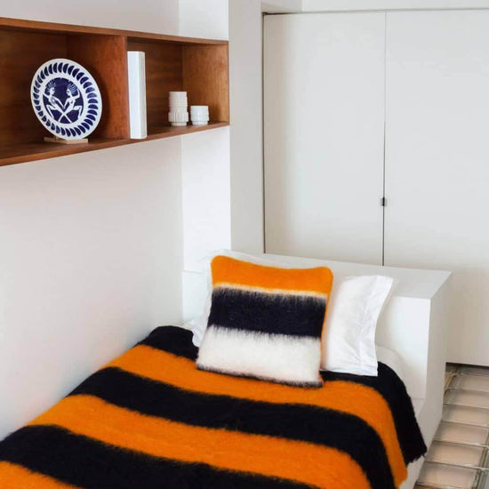 Load image into Gallery viewer, Viso Mohair Blanket Black, Orange &amp;amp; White Vertical Stripes on bed
