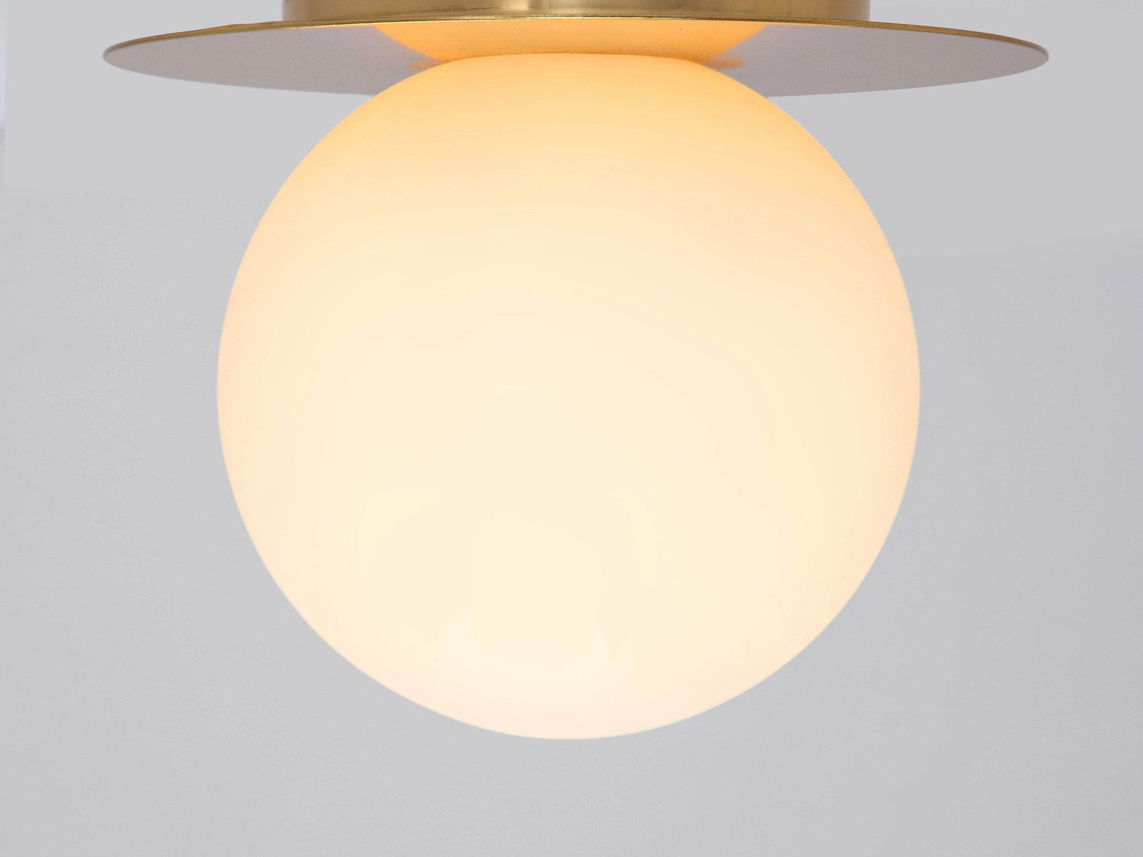 Brass opal disc wall light