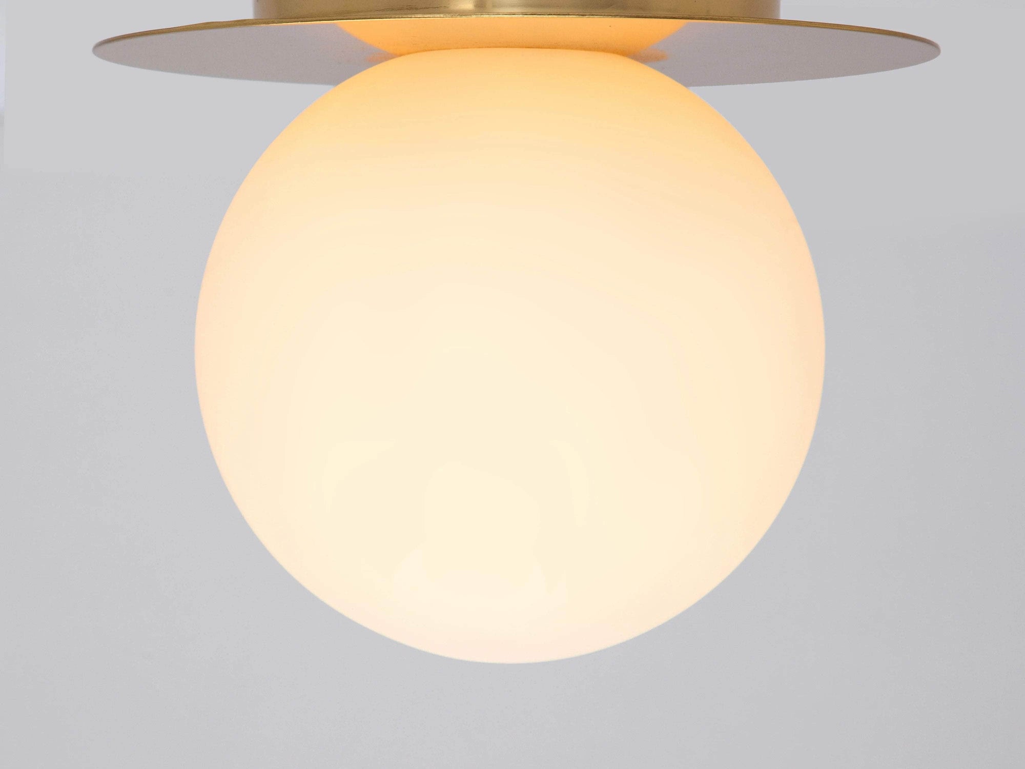 Brass opal disc wall light