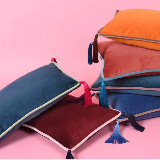 Teal velvet rectangular cushion with mint piping and fuschia tassels