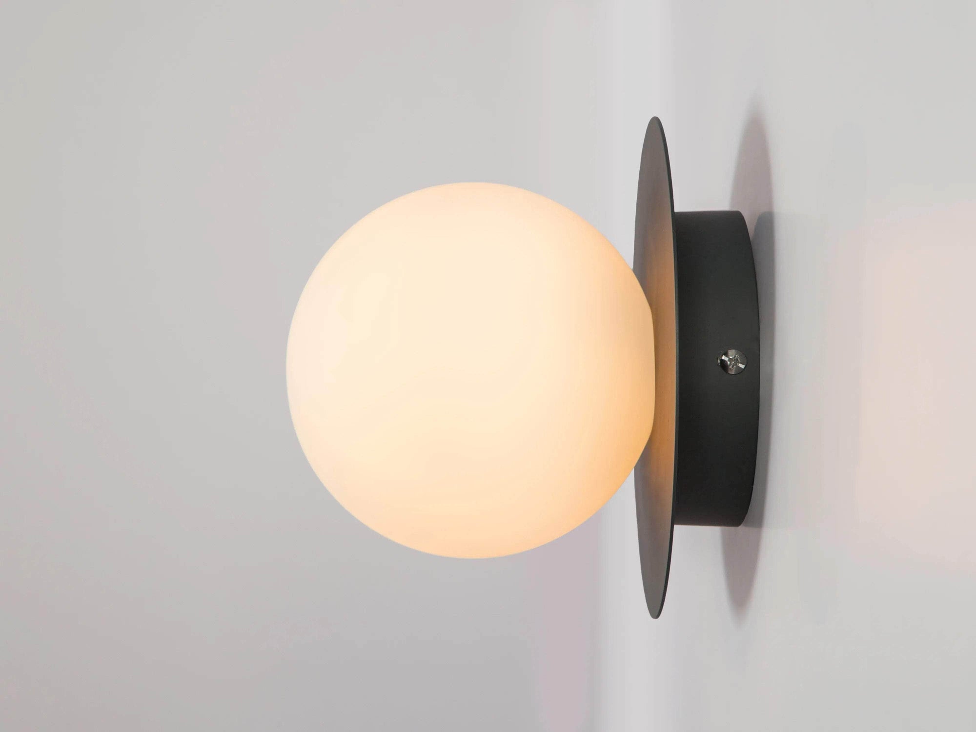 Charcoal grey opal disk wall light